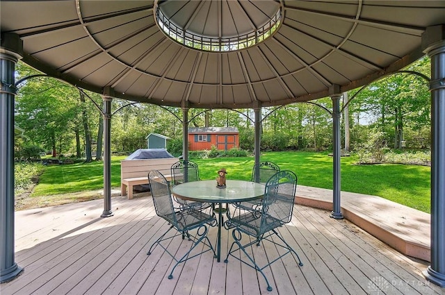 3352 Morning Glory Rd, Dayton, OH 45449 - deck with a yard, an outbuilding, outdoor dining area, a shed, and view of wooded area
