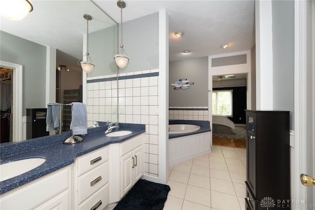 813 Timberlake Ct, Kettering, OH 45429 - bathroom featuring tile patterned floors, double vanity, a bath, and a walk in closet