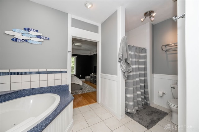 813 Timberlake Ct, Kettering, OH 45429 - bathroom featuring a wainscoted wall, tile patterned flooring, connected bathroom, a tub with jets, and toilet