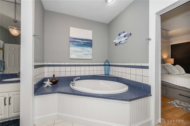 813 Timberlake Ct, Kettering, OH 45429 - full bath with a garden tub, connected bathroom, vanity, and wood finished floors