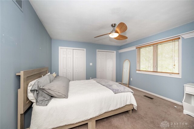 813 Timberlake Ct, Kettering, OH 45429 - carpeted bedroom with two closets, baseboards, and ceiling fan
