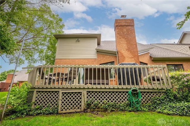 813 Timberlake Ct, Kettering, OH 45429 - back of house with brick siding, a deck, a chimney, and roof with shingles