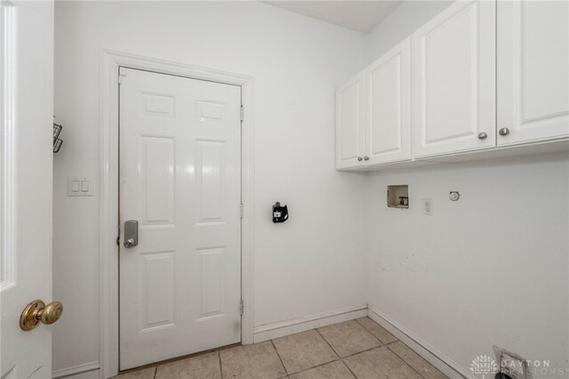 813 Timberlake Ct, Kettering, OH 45429 - washroom with cabinet space, light tile patterned flooring, baseboards, and washer hookup