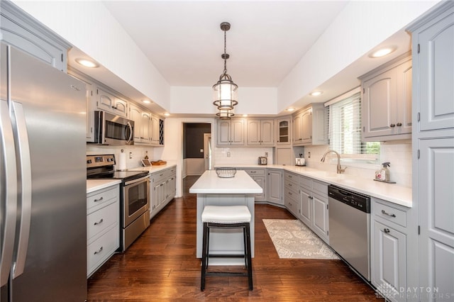 813 Timberlake Ct, Kettering, OH 45429 - kitchen featuring appliances with stainless steel finishes, a sink, a center island, backsplash, and dark wood-type flooring
