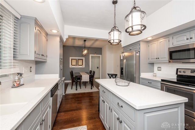 813 Timberlake Ct, Kettering, OH 45429 - kitchen with appliances with stainless steel finishes, gray cabinetry, decorative backsplash, a sink, and dark wood-style flooring