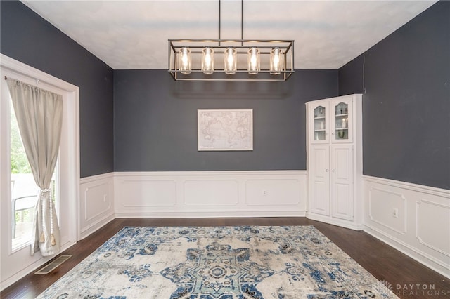 813 Timberlake Ct, Kettering, OH 45429 - unfurnished dining area with a chandelier, dark wood-style flooring, and wainscoting