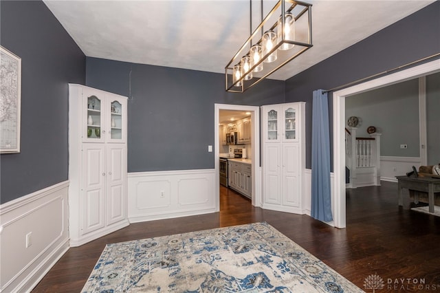 813 Timberlake Ct, Kettering, OH 45429 - dining room with wainscoting, dark wood-style flooring, and a chandelier