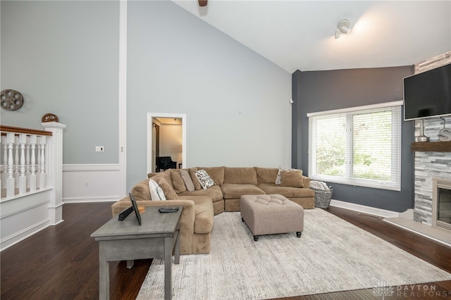 813 Timberlake Ct, Kettering, OH 45429 - living room with a large fireplace, dark wood-style flooring, high vaulted ceiling, and baseboards