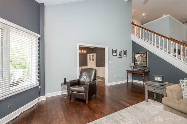 813 Timberlake Ct, Kettering, OH 45429 - living area featuring a towering ceiling, wood finished floors, healthy amount of natural light, stairs, and baseboards