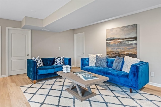 living area featuring wood finished floors and baseboards