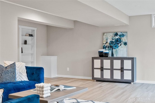 living area with wood finished floors and baseboards