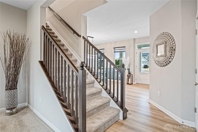 stairway with baseboards, recessed lighting, and wood finished floors