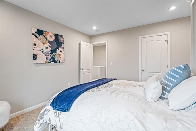 carpeted bedroom featuring baseboards and recessed lighting