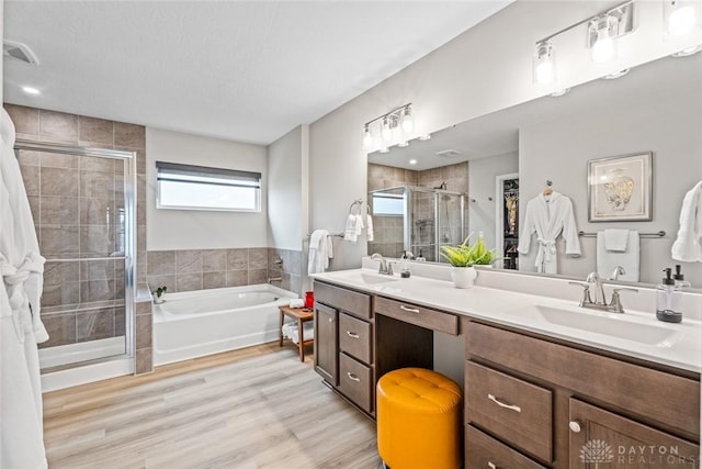 1239 Champion Way, Washington Twp, OH 45458 - bathroom with a shower stall, a garden tub, double vanity, and wood finished floors