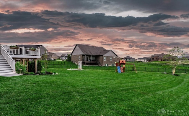 view of yard featuring stairs, a playground, and a wooden deck