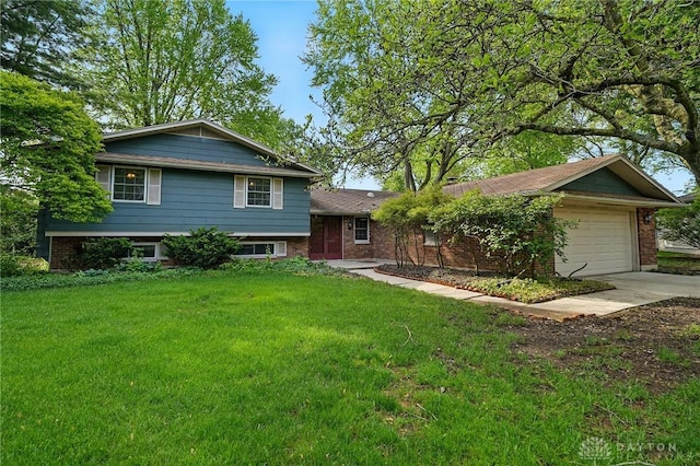 1450 Peck Ln, Dayton, OH 45459 - split level home featuring a front yard, driveway, brick siding, and a garage