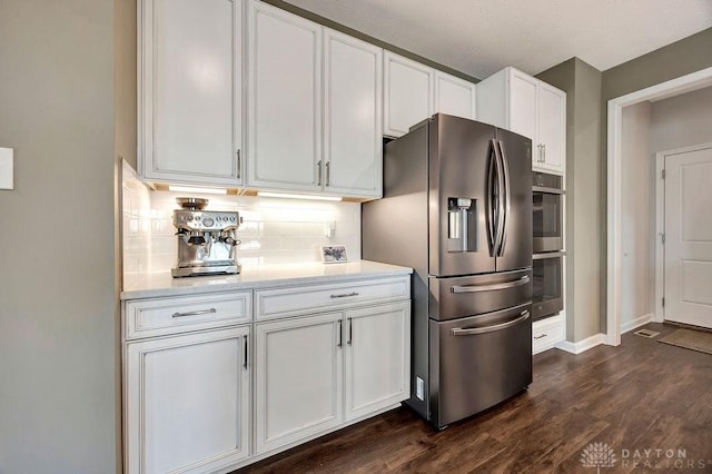 3732 Oak Creek Dr, Sugarcreek Township, OH 45440 - kitchen with stainless steel appliances, white cabinetry, backsplash, dark wood-type flooring, and light stone countertops