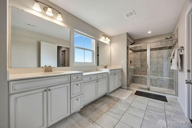 3732 Oak Creek Dr, Sugarcreek Township, OH 45440 - bathroom with double vanity, a stall shower, tile patterned floors, and baseboards