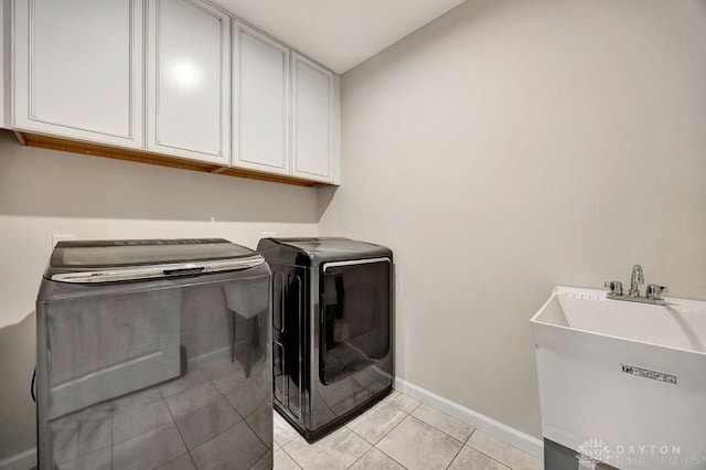 3732 Oak Creek Dr, Sugarcreek Township, OH 45440 - laundry area with cabinet space, washing machine and clothes dryer, baseboards, and light tile patterned floors