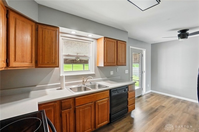 3700 Echo Hill Ln, Beavercreek, OH 45430 - kitchen featuring dishwasher, a sink, light countertops, light wood-style flooring, and brown cabinets