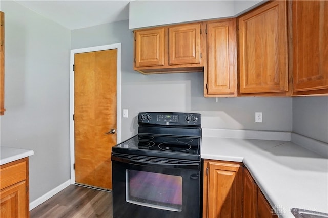 3700 Echo Hill Ln, Beavercreek, OH 45430 - kitchen featuring black range with electric cooktop, dark wood-style flooring, light countertops, and brown cabinets