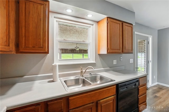 3700 Echo Hill Ln, Beavercreek, OH 45430 - kitchen featuring black dishwasher, a sink, wood finished floors, light countertops, and recessed lighting