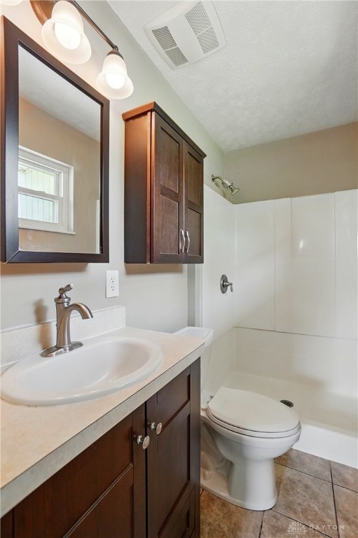 3700 Echo Hill Ln, Beavercreek, OH 45430 - bathroom with toilet, a shower, vanity, and tile patterned floors