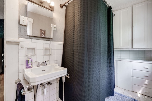 1000 Haviland Ave, Dayton, OH 45410 - full bathroom featuring tile walls, a shower with shower curtain, wainscoting, and a sink