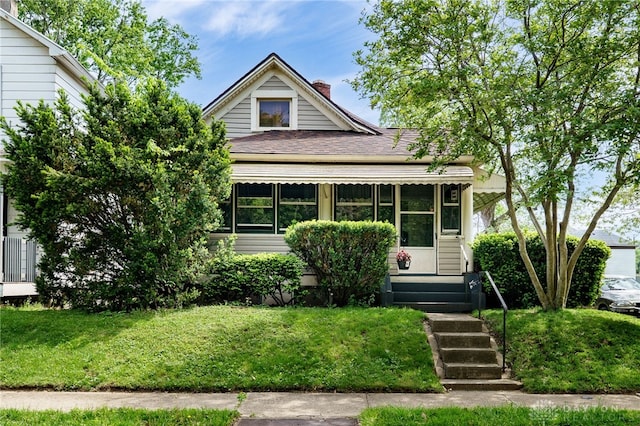 1000 Haviland Ave, Dayton, OH 45410 - view of front of house with a chimney, a front yard, and a shingled roof