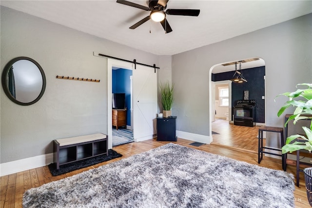 1000 Haviland Ave, Dayton, OH 45410 - living area featuring a barn door, a ceiling fan, arched walkways, and wood finished floors