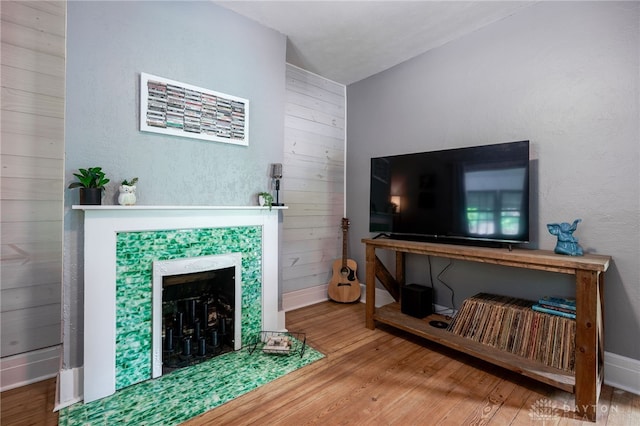 1000 Haviland Ave, Dayton, OH 45410 - living room featuring wood finished floors, a tile fireplace, and baseboards