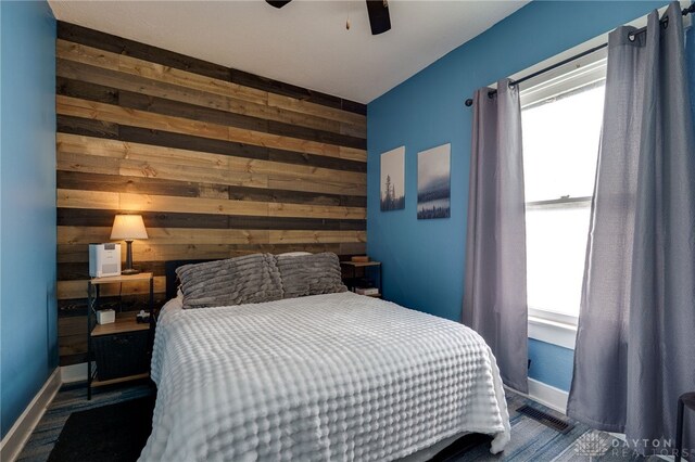 1000 Haviland Ave, Dayton, OH 45410 - bedroom with wooden walls, baseboards, and ceiling fan
