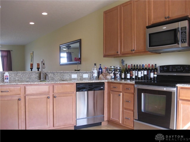 4324 Straight Arrow Rd, Beavercreek, OH 45430 - kitchen featuring appliances with stainless steel finishes, a sink, light stone counters, and recessed lighting