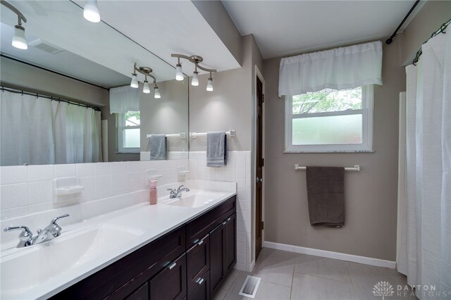 200 S Village, Washington Twp, OH 45459 - bathroom featuring tile patterned flooring, baseboards, and double vanity