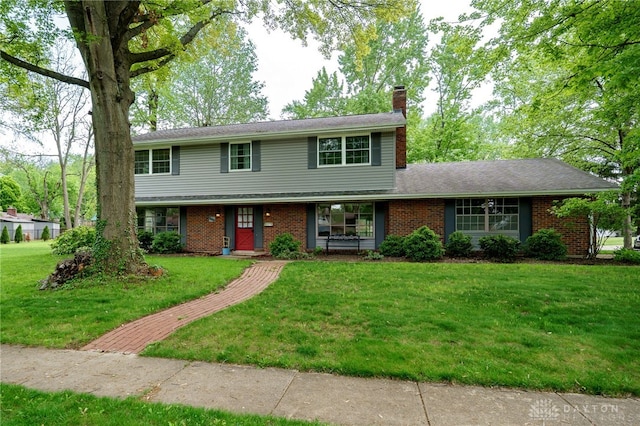 200 S Village, Washington Twp, OH 45459 - view of front facade featuring a chimney, a front yard, and brick siding