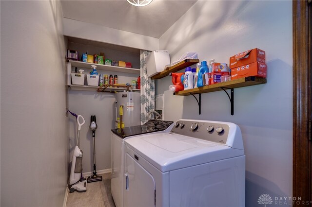 200 S Village, Washington Twp, OH 45459 - washroom with washer and clothes dryer, water heater, light wood-type flooring, and baseboards