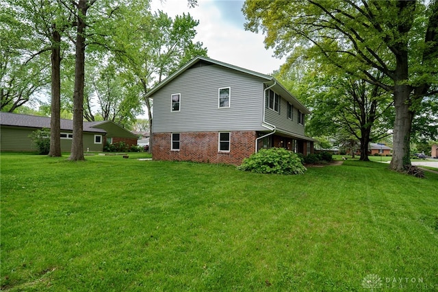200 S Village, Washington Twp, OH 45459 - rear view of house with a lawn and brick siding
