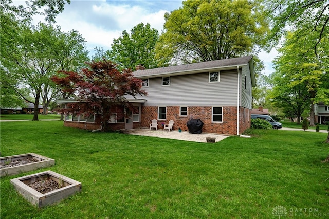 200 S Village, Washington Twp, OH 45459 - rear view of property with a patio, a lawn, brick siding, and a chimney
