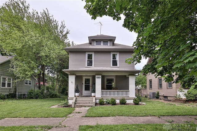 traditional style home featuring covered porch, a front lawn, and central AC unit