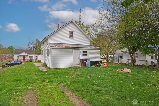back of house with metal roof