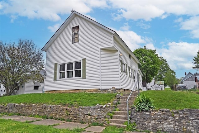 view of side of property featuring stairway