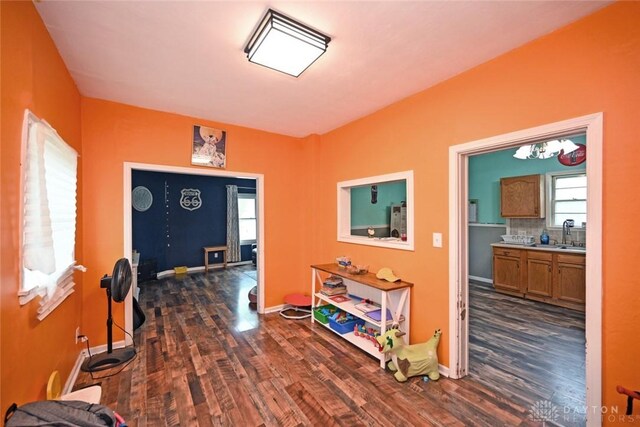 entryway featuring dark wood finished floors and baseboards