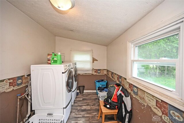 washroom with separate washer and dryer, dark wood finished floors, and a textured ceiling
