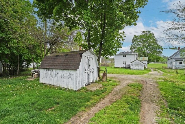 view of shed featuring driveway