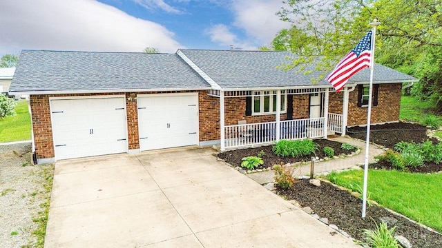 2774 N Law Rd, Oxford, OH 45056 - view of front of property with a porch, brick siding, a garage, and roof with shingles