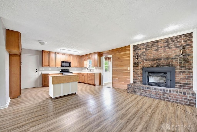 2774 N Law Rd, Oxford, OH 45056 - kitchen with black microwave, a textured ceiling, stainless steel electric range oven, light wood-style floors, and light countertops