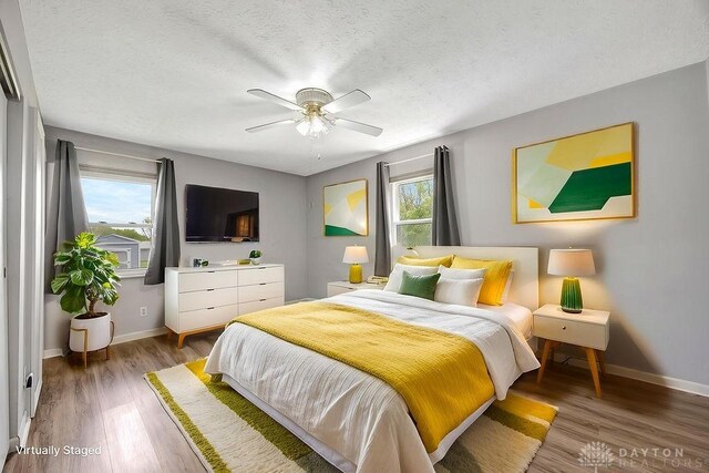 2774 N Law Rd, Oxford, OH 45056 - bedroom with baseboards, light wood-type flooring, a textured ceiling, and ceiling fan