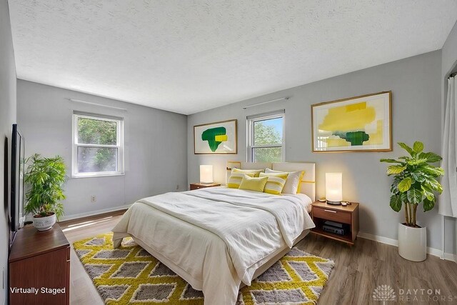 2774 N Law Rd, Oxford, OH 45056 - bedroom featuring baseboards, wood finished floors, and a textured ceiling