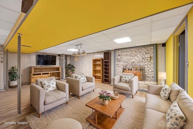 2774 N Law Rd, Oxford, OH 45056 - living area featuring wood finished floors, a paneled ceiling, and wood walls