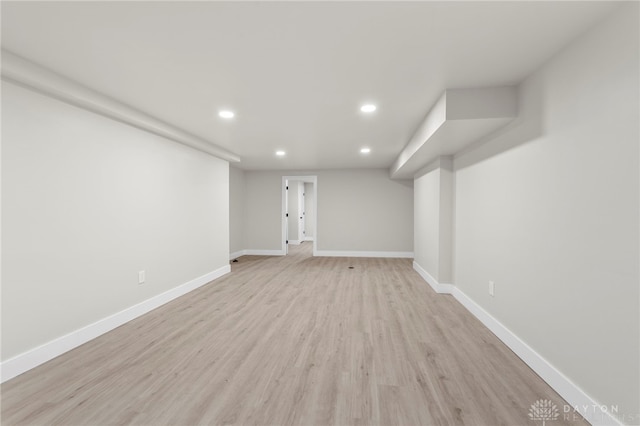 finished below grade area featuring recessed lighting, light wood-type flooring, and baseboards